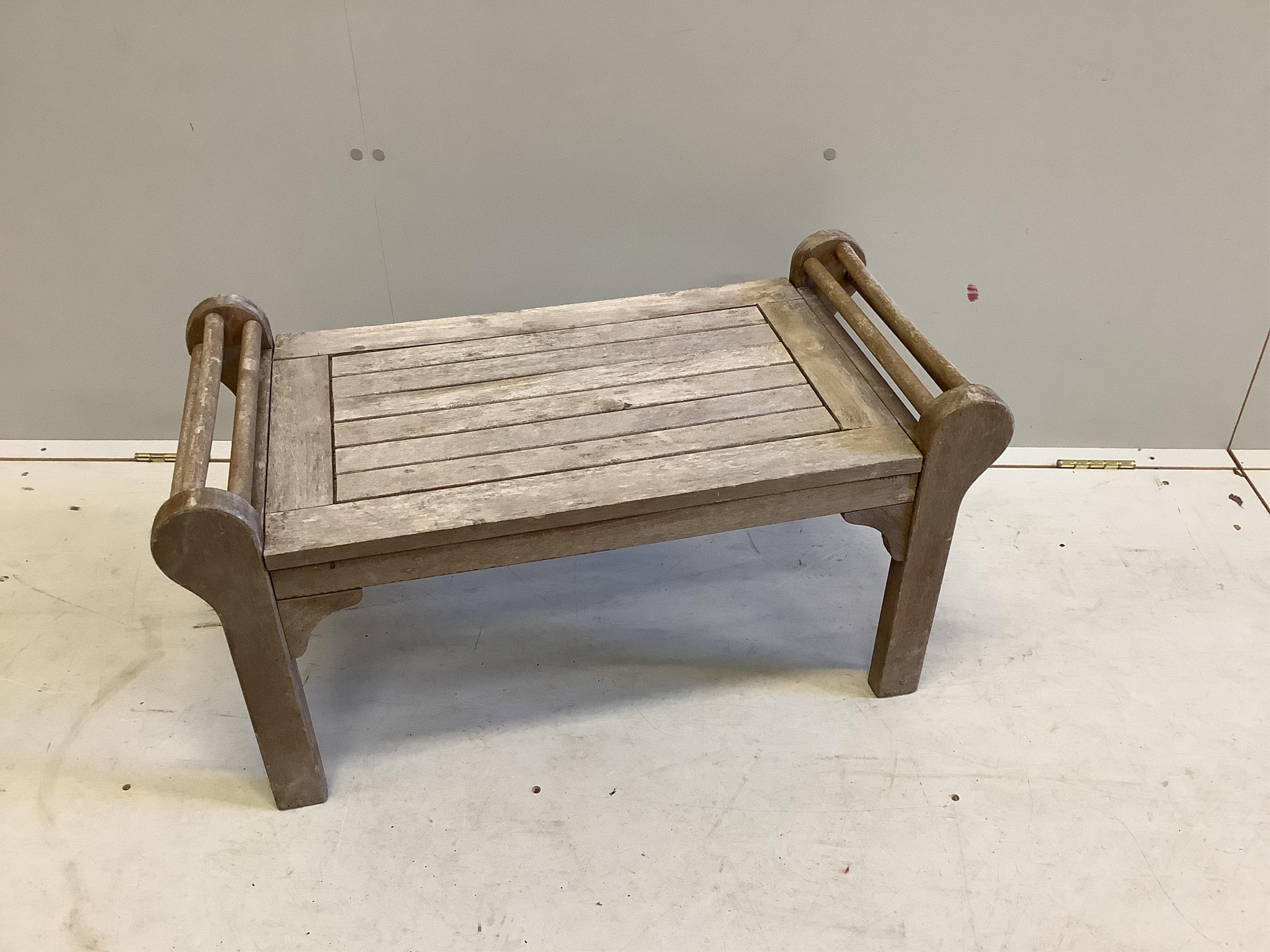 A Lutyens style teak garden bench, width 166cm, and a matching side table, width 80cm. Condition - weathered but otherwise good